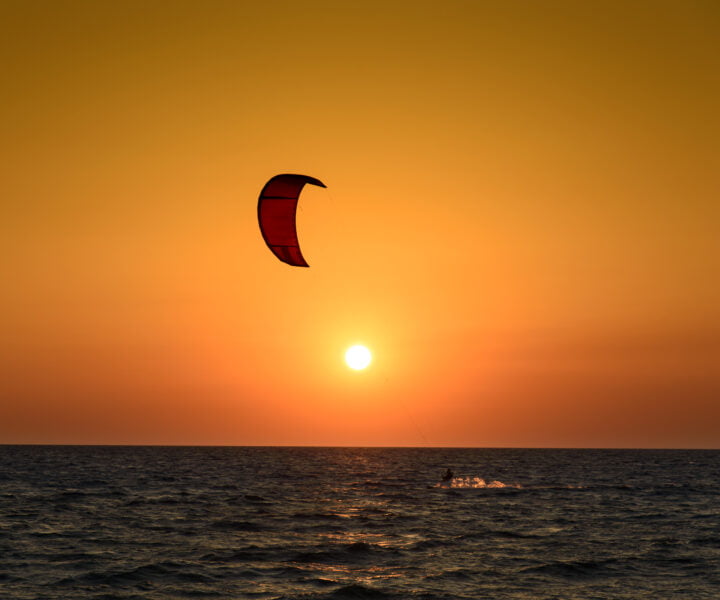 Kite surfer silhouette at beautiful sunset at the sea